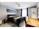 Comfortable bedroom with a ceiling fan, natural light, wooden desk, and modern furnishings at 13615 Moorcroft Dr, Fishers, IN 46037