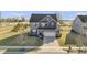 Attractive two-story home with a stone facade, a well-manicured lawn, and a spacious driveway for easy parking at 13615 Moorcroft Dr, Fishers, IN 46037