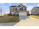 Charming two-story home with stone and siding, a well-manicured lawn, and a two-car garage at 13615 Moorcroft Dr, Fishers, IN 46037