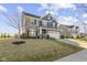 Charming two-story home with a stone and blue siding exterior and well-manicured lawn at 13615 Moorcroft Dr, Fishers, IN 46037