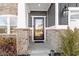 Close-up of the front door with stone accents and gray siding, creating a welcoming entrance at 13615 Moorcroft Dr, Fishers, IN 46037