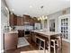 Kitchen featuring dark cabinets, granite countertops, island, and stainless steel appliances at 13615 Moorcroft Dr, Fishers, IN 46037