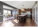 A kitchen with dark cabinets, granite counters, island, and stainless steel appliances at 13615 Moorcroft Dr, Fishers, IN 46037
