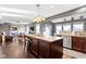 Open kitchen with island and pendant lighting flows into the living spaces at 13615 Moorcroft Dr, Fishers, IN 46037
