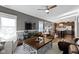 Open concept living room with ceiling fan, a large area rug and adjacent kitchen at 13615 Moorcroft Dr, Fishers, IN 46037