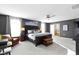 Spacious main bedroom with neutral tones, ceiling fan, and ensuite bathroom view at 13615 Moorcroft Dr, Fishers, IN 46037