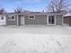 Exterior shot of the backyard covered in snow with sliding doors at 1378 South St, Noblesville, IN 46060