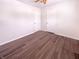 Well-lit bedroom with wood-look flooring, ceiling fan, and two white doors, enhancing its charm at 1378 South St, Noblesville, IN 46060