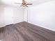 A clean bedroom with wood-look flooring, a ceiling fan, and two doors, one leading to a closet at 1378 South St, Noblesville, IN 46060