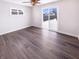 Bright bedroom features wood-look flooring, a ceiling fan, a window, and sliding glass doors to the yard at 1378 South St, Noblesville, IN 46060
