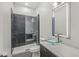 Chic bathroom features a glass bowl sink and glass-enclosed shower with decorative tiles at 1510 Columbia Ave, Indianapolis, IN 46202