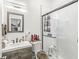 Modern bathroom featuring a sleek vanity, glass-enclosed shower, and contemporary fixtures, with an artistic mirror at 1510 Columbia Ave, Indianapolis, IN 46202