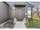 Close up of the modern front door with stylish lighting and manicured landscaping at 1510 Columbia Ave, Indianapolis, IN 46202