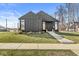 Contemporary home with sleek siding, green lawn, and inviting concrete path leading to the entrance at 1510 Columbia Ave, Indianapolis, IN 46202