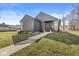 Modern home with striking black siding, well-maintained lawn, and a concrete walkway at 1510 Columbia Ave, Indianapolis, IN 46202