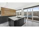 Kitchen with a sleek island, modern sink and fixtures, and a view of the outdoor pool at 1510 Columbia Ave, Indianapolis, IN 46202