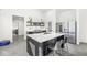 Modern kitchen with an island, stainless steel appliances, and bright lighting with backyard views at 1510 Columbia Ave, Indianapolis, IN 46202