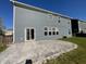 Backyard featuring a gray concrete patio with sliding glass door access from a home with blue siding at 15704 Millwood Dr, Noblesville, IN 46060