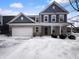 Charming two-story home featuring a brick facade, attached garage, and beautiful architectural details at 15704 Millwood Dr, Noblesville, IN 46060
