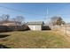 The backyard features a well-kept lawn, a privacy fence, and a storage shed at 1718 Gilmore St, Columbus, IN 47201