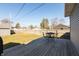 The backyard features a wooden deck with outdoor seating and a well-kept lawn at 1718 Gilmore St, Columbus, IN 47201