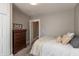 Bedroom featuring a dresser, closet, and comfortable bed with decorative pillows at 1718 Gilmore St, Columbus, IN 47201