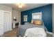 Comfortable bedroom features blue accent wall, plush carpet, and desk area at 1718 Gilmore St, Columbus, IN 47201
