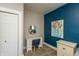 Bright bedroom with blue accent wall, closet, desk, and natural light at 1718 Gilmore St, Columbus, IN 47201