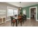 Dining room featuring a wood table, decorative lighting, and ample natural light from multiple windows at 1718 Gilmore St, Columbus, IN 47201