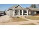 Charming home featuring a cozy front porch with a swing, white pillars, and meticulous landscaping at 1718 Gilmore St, Columbus, IN 47201