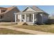 Cozy home with gray siding, a welcoming porch with a swing, and a neatly maintained front lawn at 1718 Gilmore St, Columbus, IN 47201