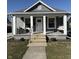Charming home features a welcoming front porch with swing and seating, enhancing curb appeal at 1718 Gilmore St, Columbus, IN 47201