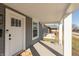Covered front porch with a swing and seating near the home's white front door at 1718 Gilmore St, Columbus, IN 47201