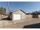 The property features a detached garage with a single-car garage door and a gravel driveway at 1718 Gilmore St, Columbus, IN 47201