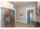 View of the kitchen featuring stainless steel refrigerator and wood flooring at 1718 Gilmore St, Columbus, IN 47201