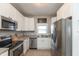 Bright kitchen featuring stainless steel appliances, white cabinetry, and stylish countertop design at 1718 Gilmore St, Columbus, IN 47201