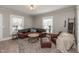 Cozy living room with hardwood floors, a leather sofa set, and large windows for natural light at 1718 Gilmore St, Columbus, IN 47201