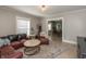 Spacious living room with hardwood floors, an L-shaped sofa, and seamless access to the dining area at 1718 Gilmore St, Columbus, IN 47201