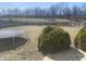 Fenced backyard featuring a trampoline, mature shrubbery, and plenty of space for outdoor activities at 1735 Sonesta Ln, Indianapolis, IN 46217