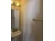 A well-lit half bathroom features a classic pedestal sink, mirror, and towel rack at 1735 Sonesta Ln, Indianapolis, IN 46217