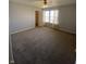 Spacious bedroom featuring neutral walls, plush carpeting, and a window with natural light at 1735 Sonesta Ln, Indianapolis, IN 46217