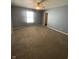 Bright bedroom with large window, ceiling fan and neutral carpeting offers a serene retreat at 1735 Sonesta Ln, Indianapolis, IN 46217
