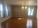 Bright dining room featuring hardwood floors, large windows, and a stylish chandelier at 1735 Sonesta Ln, Indianapolis, IN 46217