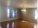 Bright dining room with wood flooring, a classic light fixture, and natural light from large windows at 1735 Sonesta Ln, Indianapolis, IN 46217