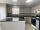 A modern kitchen showcases stainless steel appliances, an island, and lots of space to enjoy cooking at 1735 Sonesta Ln, Indianapolis, IN 46217