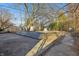 Fenced backyard with a concrete patio, sheds, and trees at 1953 N Linwood Ave, Indianapolis, IN 46218