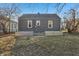 Exterior view of the home's backyard featuring garden beds and gray siding at 1953 N Linwood Ave, Indianapolis, IN 46218