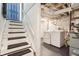 White painted basement staircase leads to a laundry area with washer and dryer at 1953 N Linwood Ave, Indianapolis, IN 46218