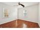 A bright bedroom with hardwood floors, two windows, and ceiling fan at 1953 N Linwood Ave, Indianapolis, IN 46218