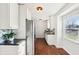 Bright and airy kitchen with white cabinets, stainless steel appliances, and a window with natural light, creating a pleasant atmosphere at 1953 N Linwood Ave, Indianapolis, IN 46218